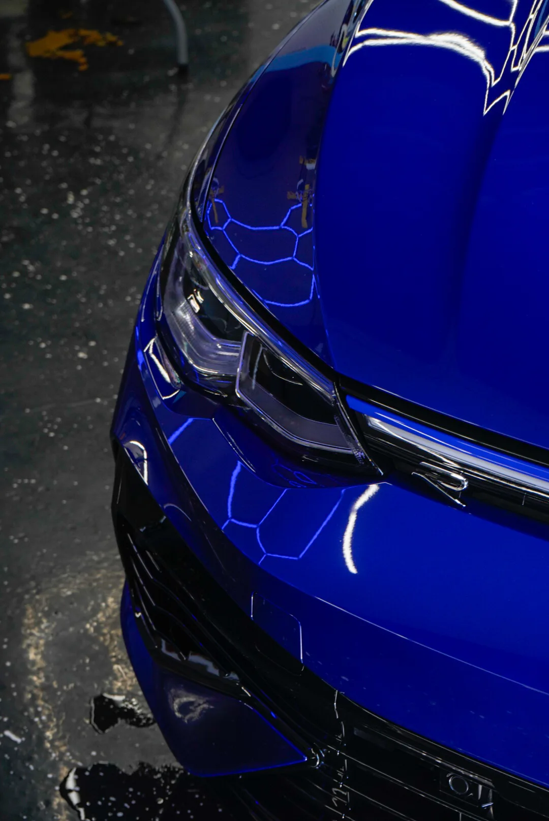 Water beading on a freshly ceramic-coated blue hood