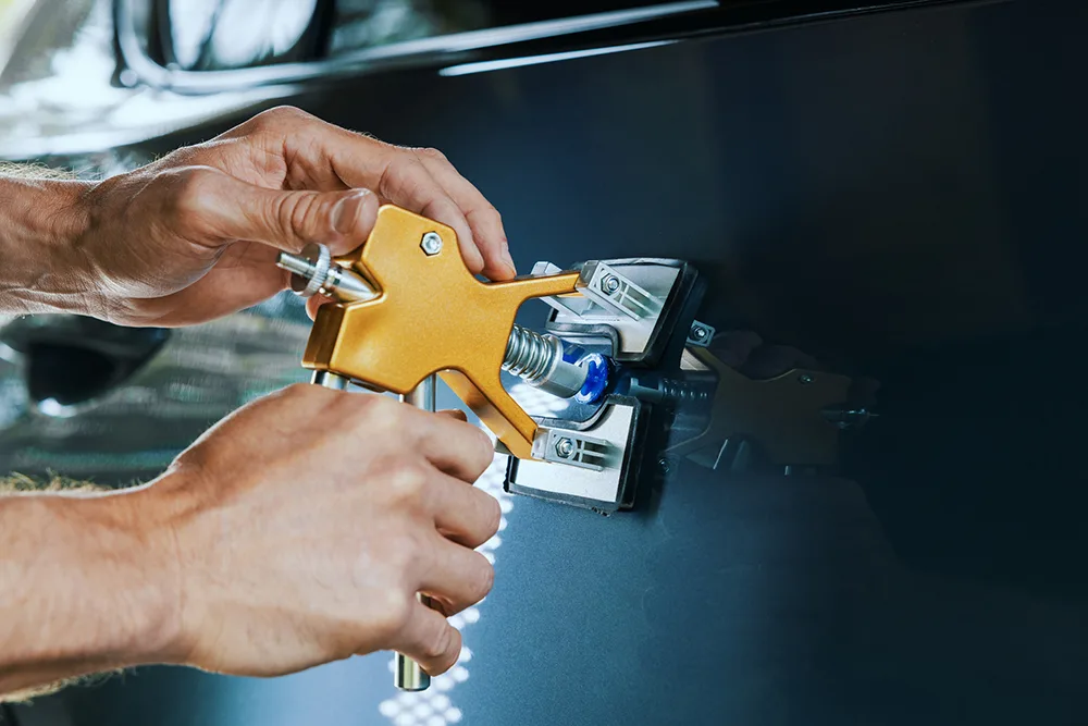 Paintless dent repair tool pulling a dent